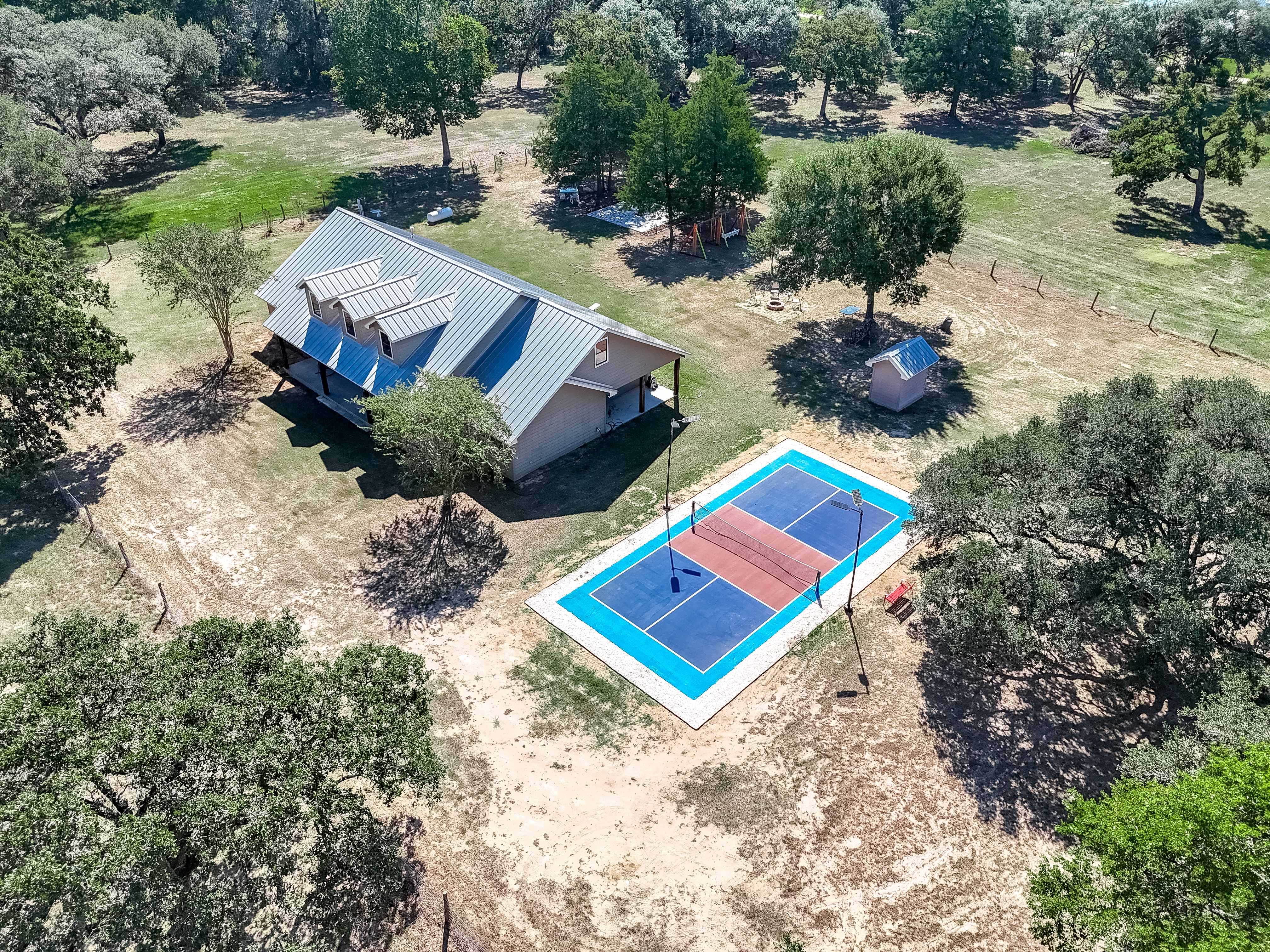 Partial estate showing house and pickleball court from above